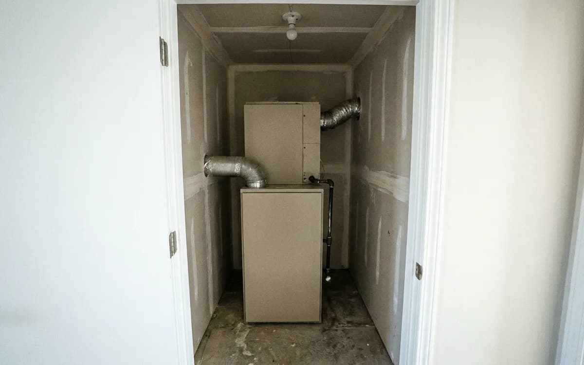 Builder-installed gas furnace in a newer home mechanical closet