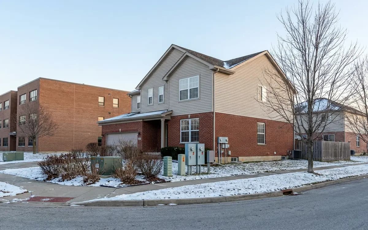 Aurora suburban home beside an unmarked civic building in winter