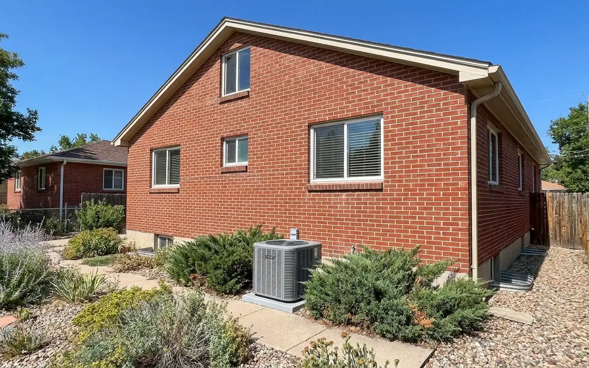 Unnumbered brick home with a generic outdoor condenser