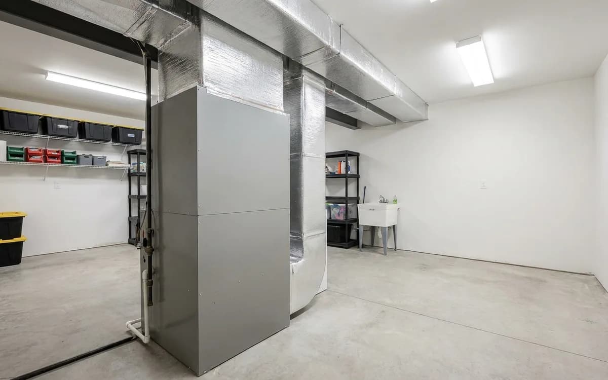 Plain enclosed unbranded furnace and ductwork in a clean utility room