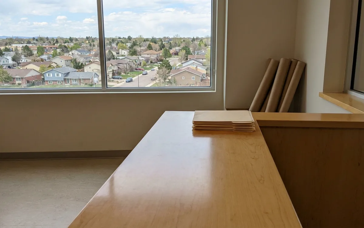 Blank municipal service desk with folders and plan tubes