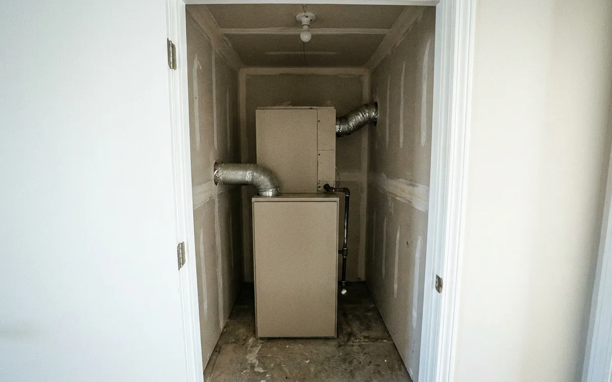 Builder-installed gas furnace in a newer home mechanical closet
