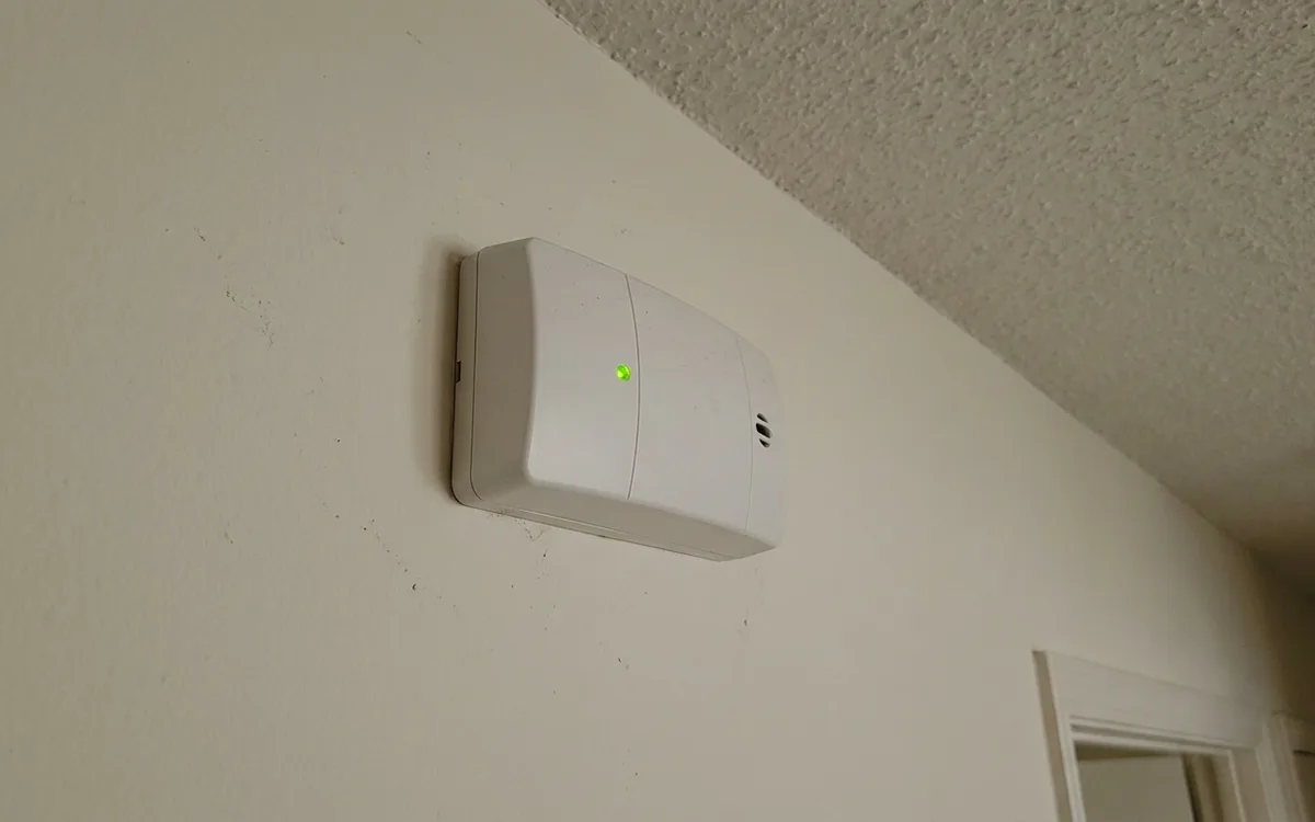 Carbon monoxide detector mounted on a residential hallway wall